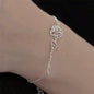 Delicate silver bracelet featuring a rose and custom name charm