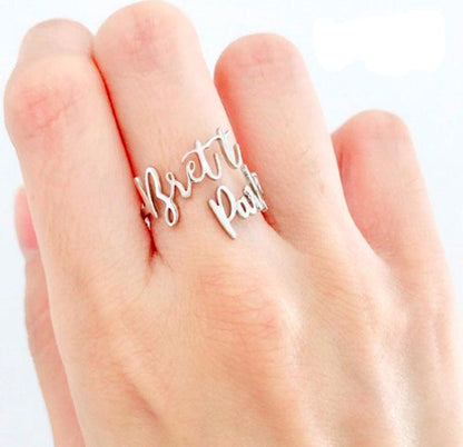 Personalized Love Script Ring on a jewelry display
